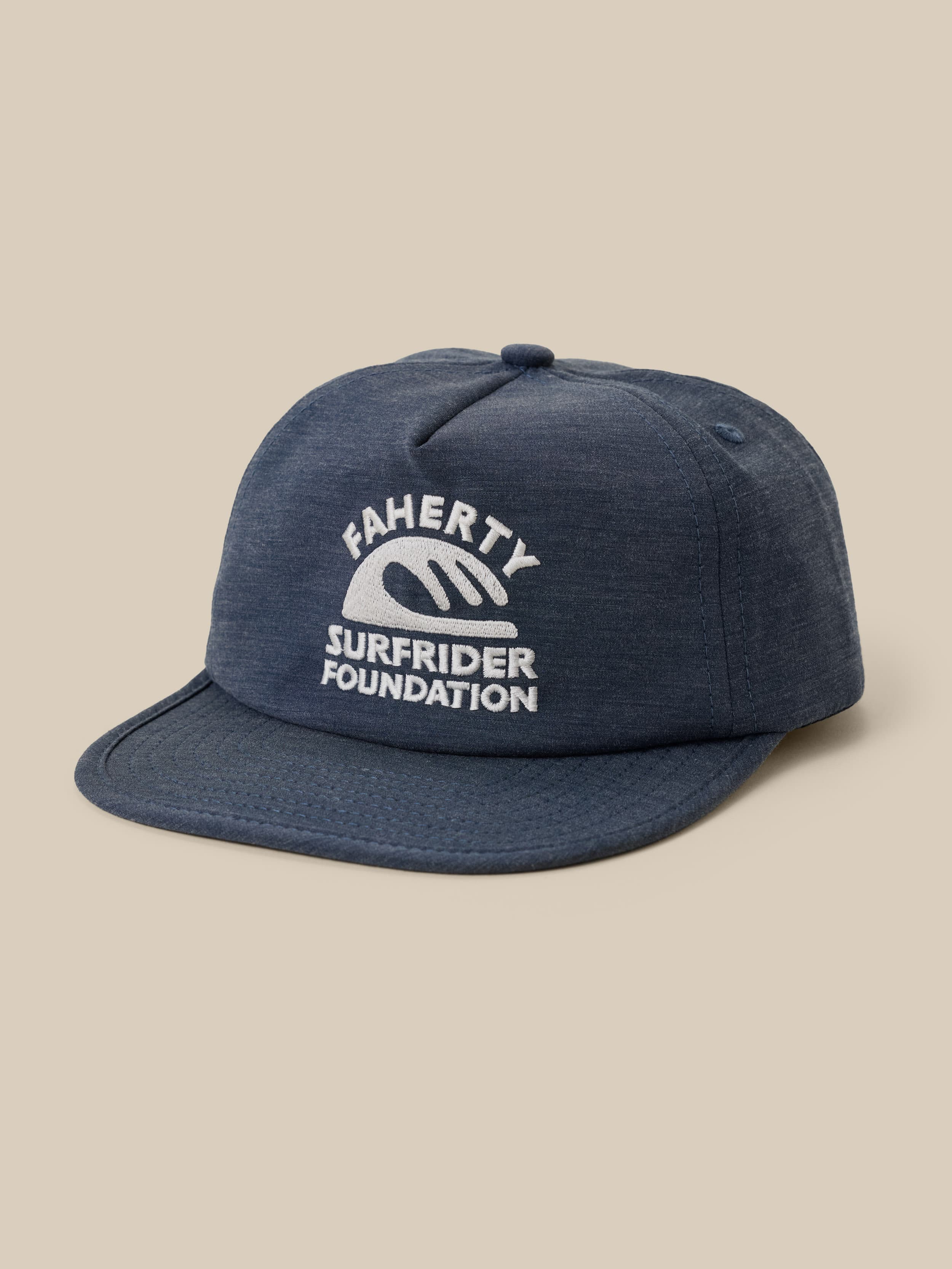 Blue cap with 'Faherty x Surfrider Foundation' logo on a beige background