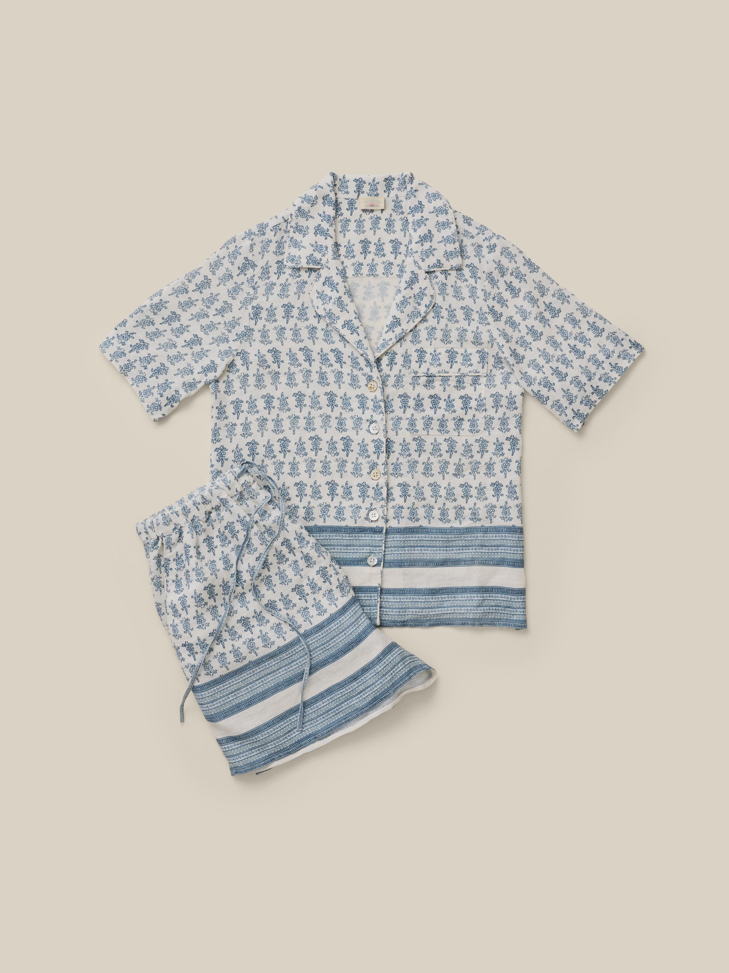 Blue patterned pajama set on a beige background