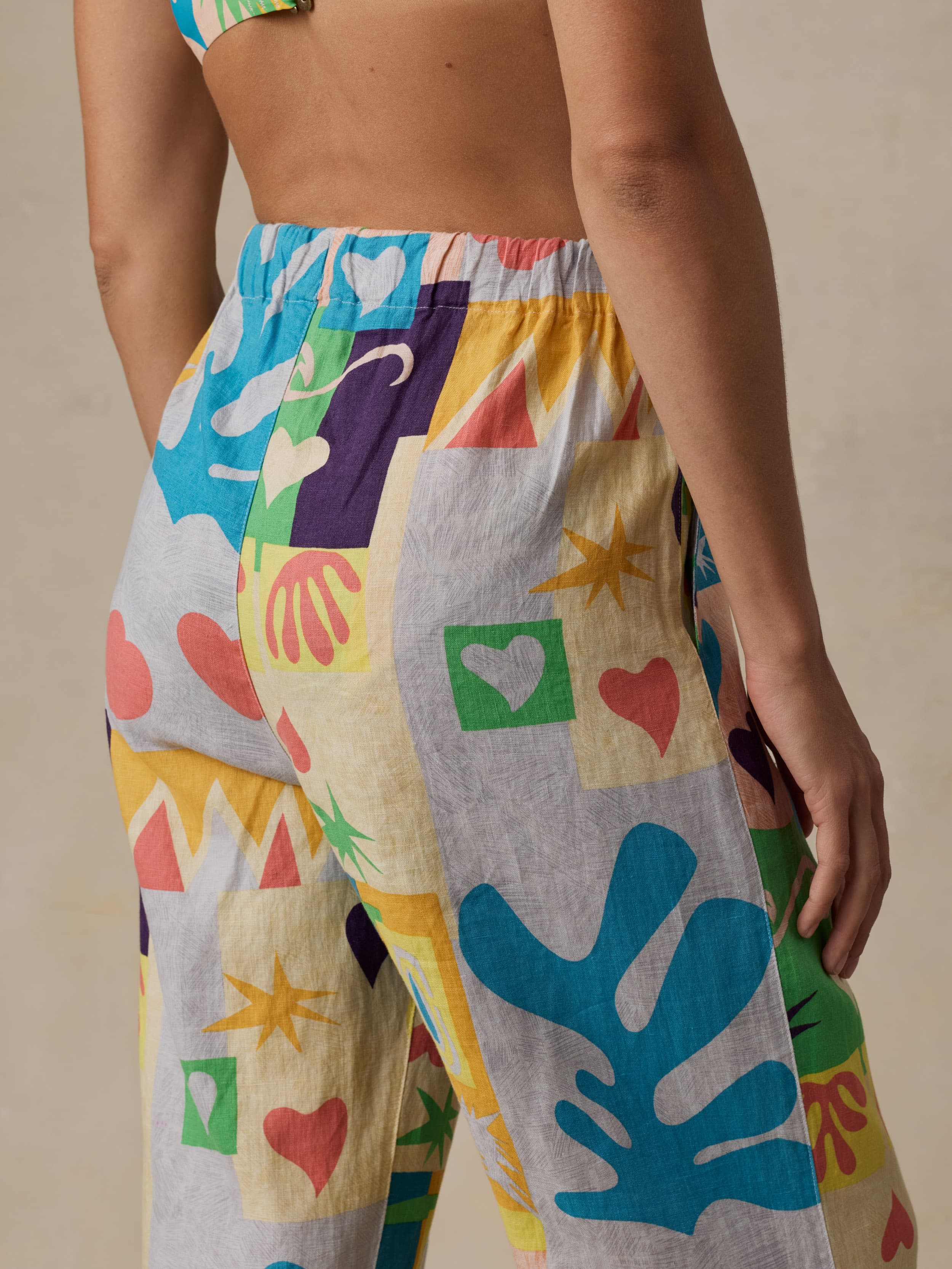 Colorful patterned pants with abstract designs on a neutral background