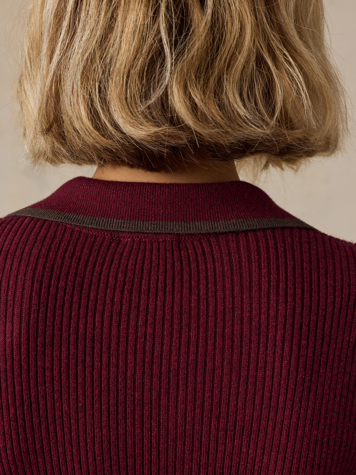 Close up of a woman viewed from behind wearing a burgundy dress, image 5 of 7