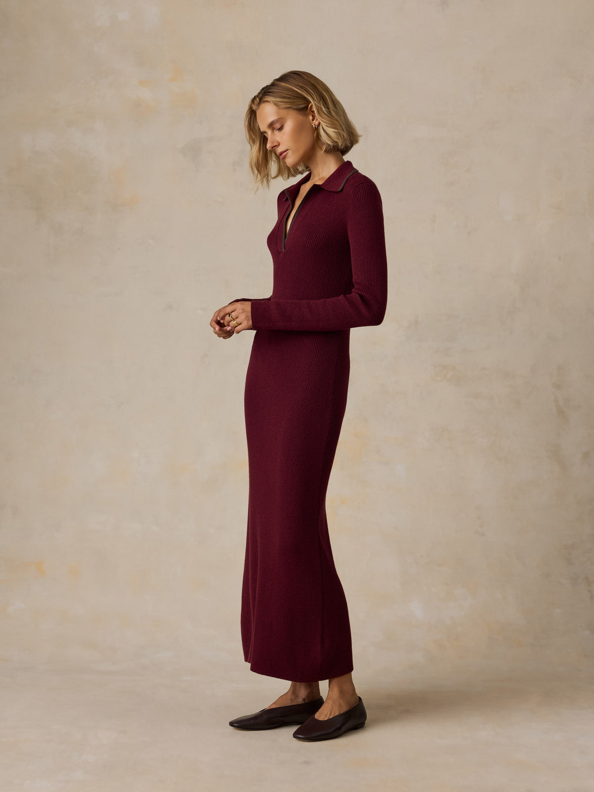 A woman wearing a burgundy dress and flats, image 7 of 7