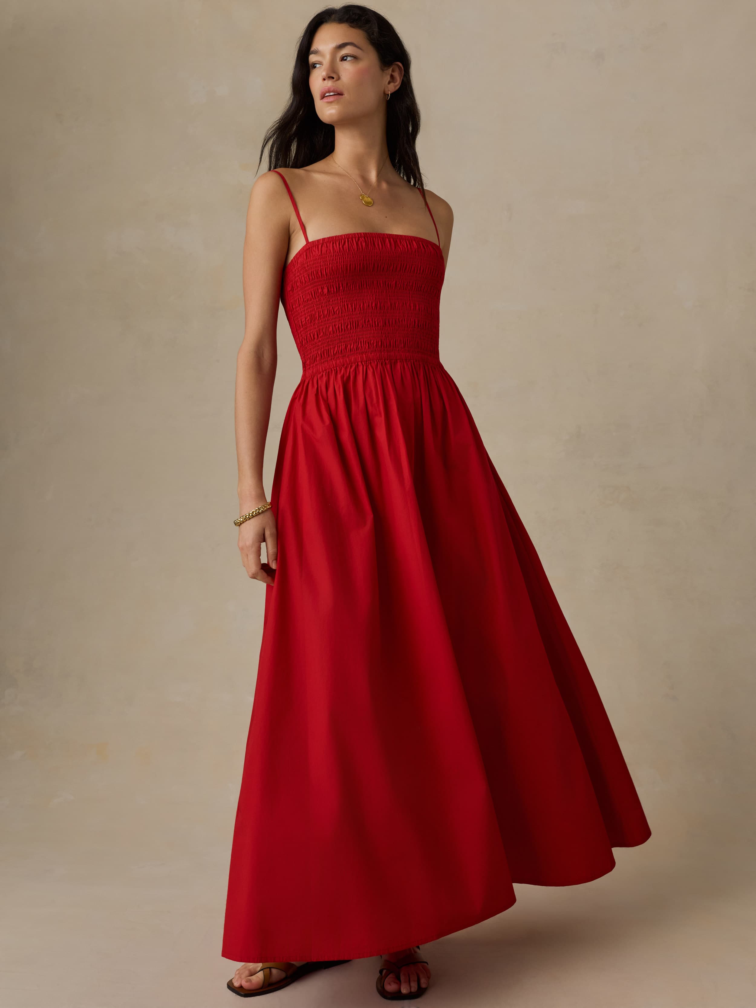 Woman wearing a red dress against a beige background