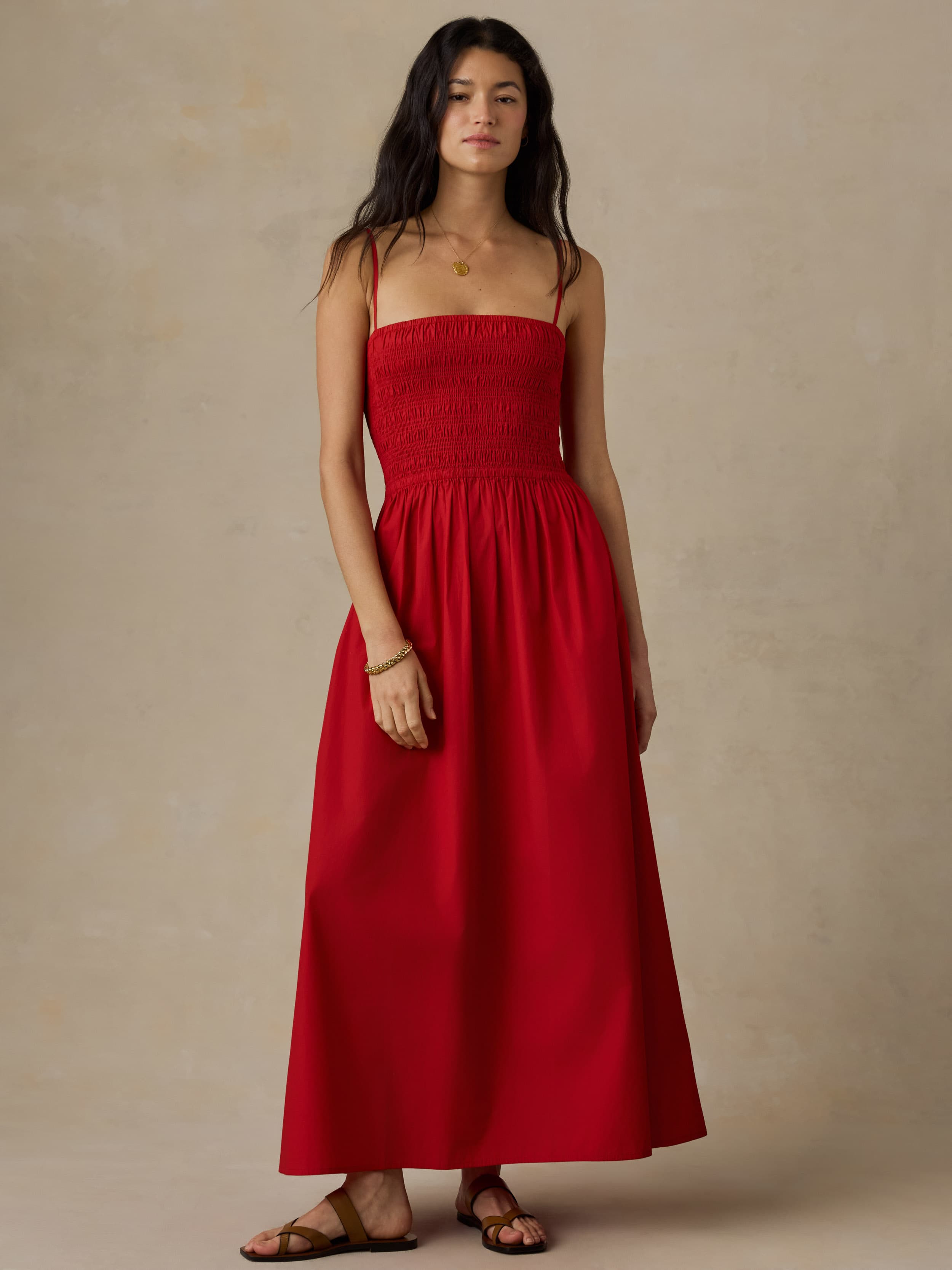 Woman wearing a red dress against a beige background
