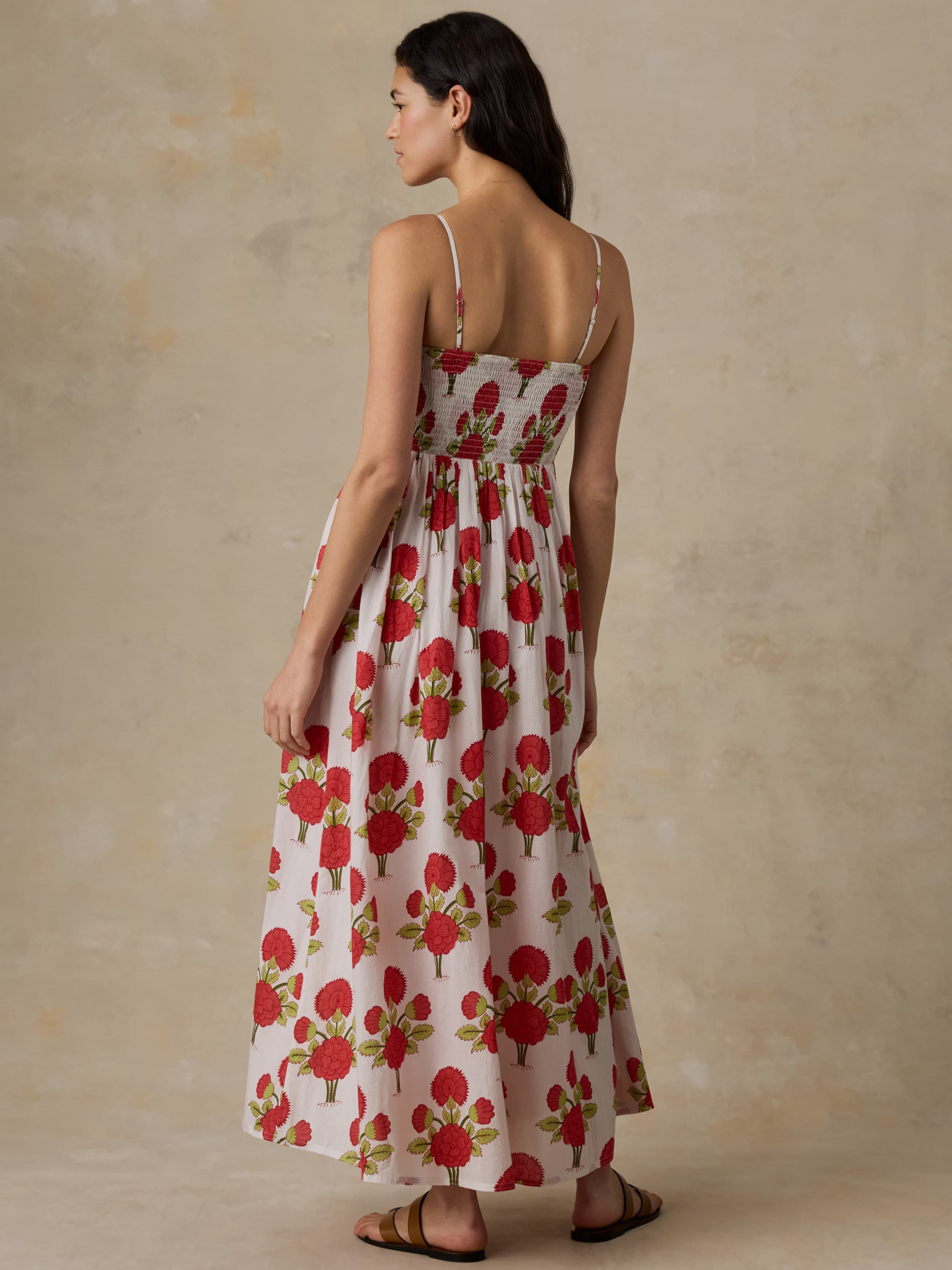 Woman wearing a floral dress with a beige background