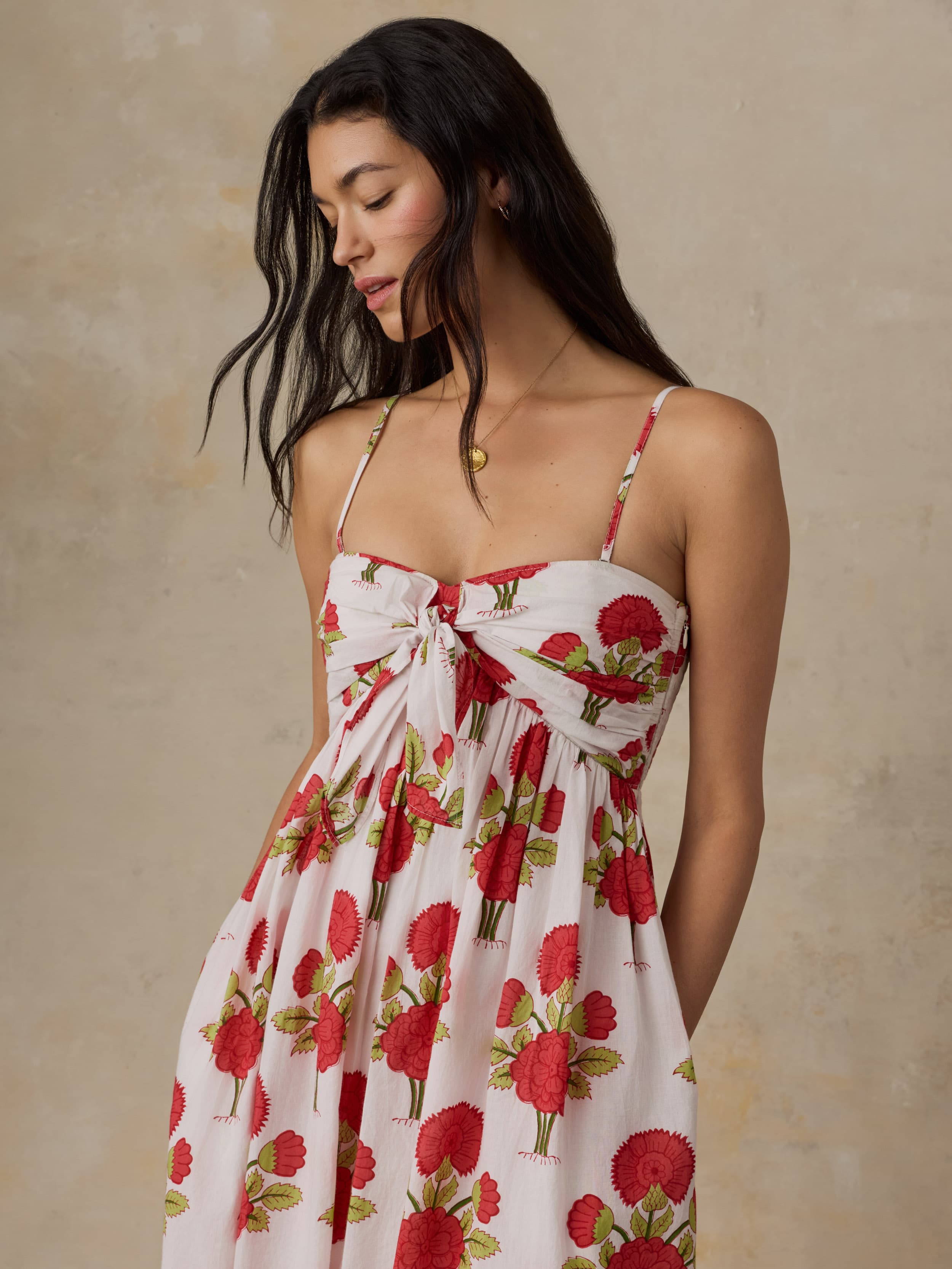 Woman wearing a floral dress with a beige background