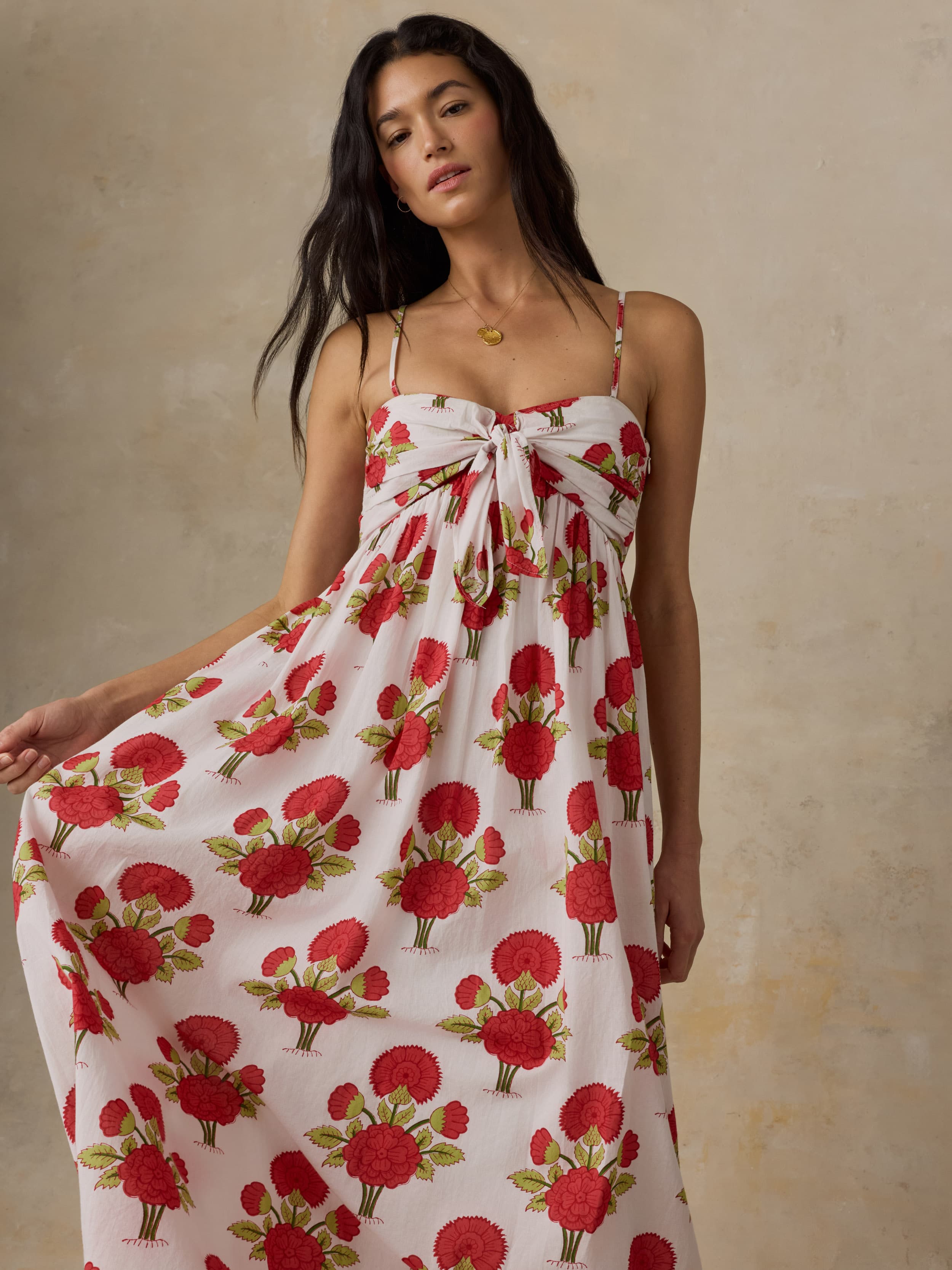 Woman wearing a floral dress with a beige background