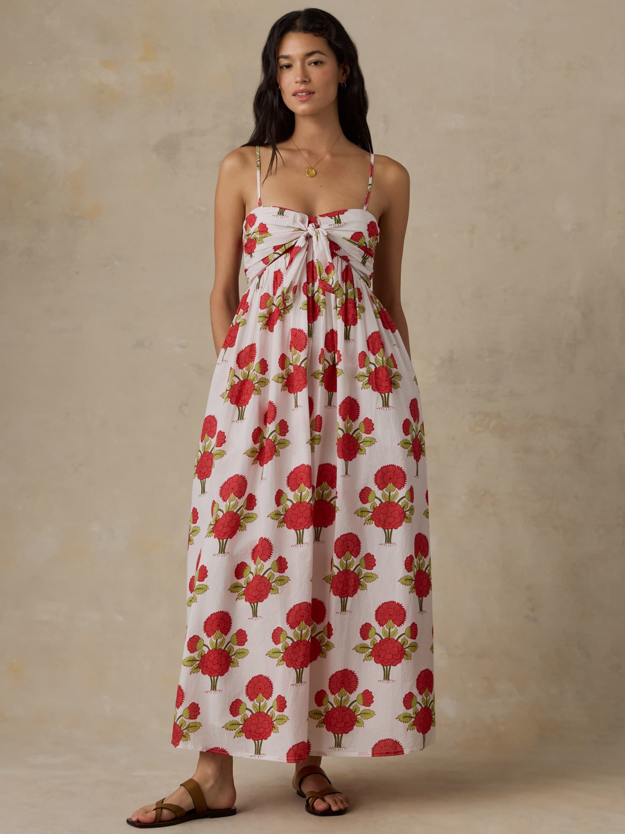 Woman wearing a floral dress with a beige background