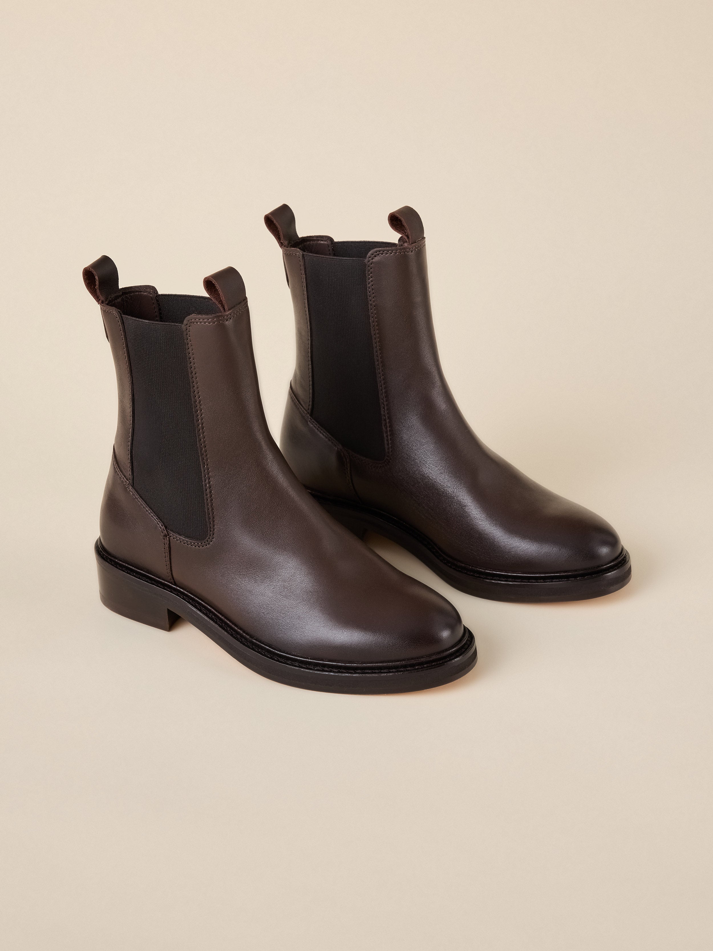 A pair of brown leather chelsea boots
