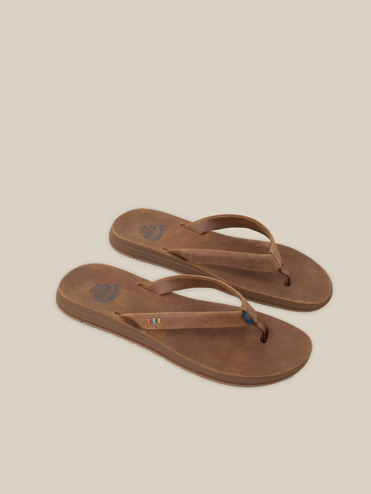 Pair of brown sandals on a beige background, image 3 of 3