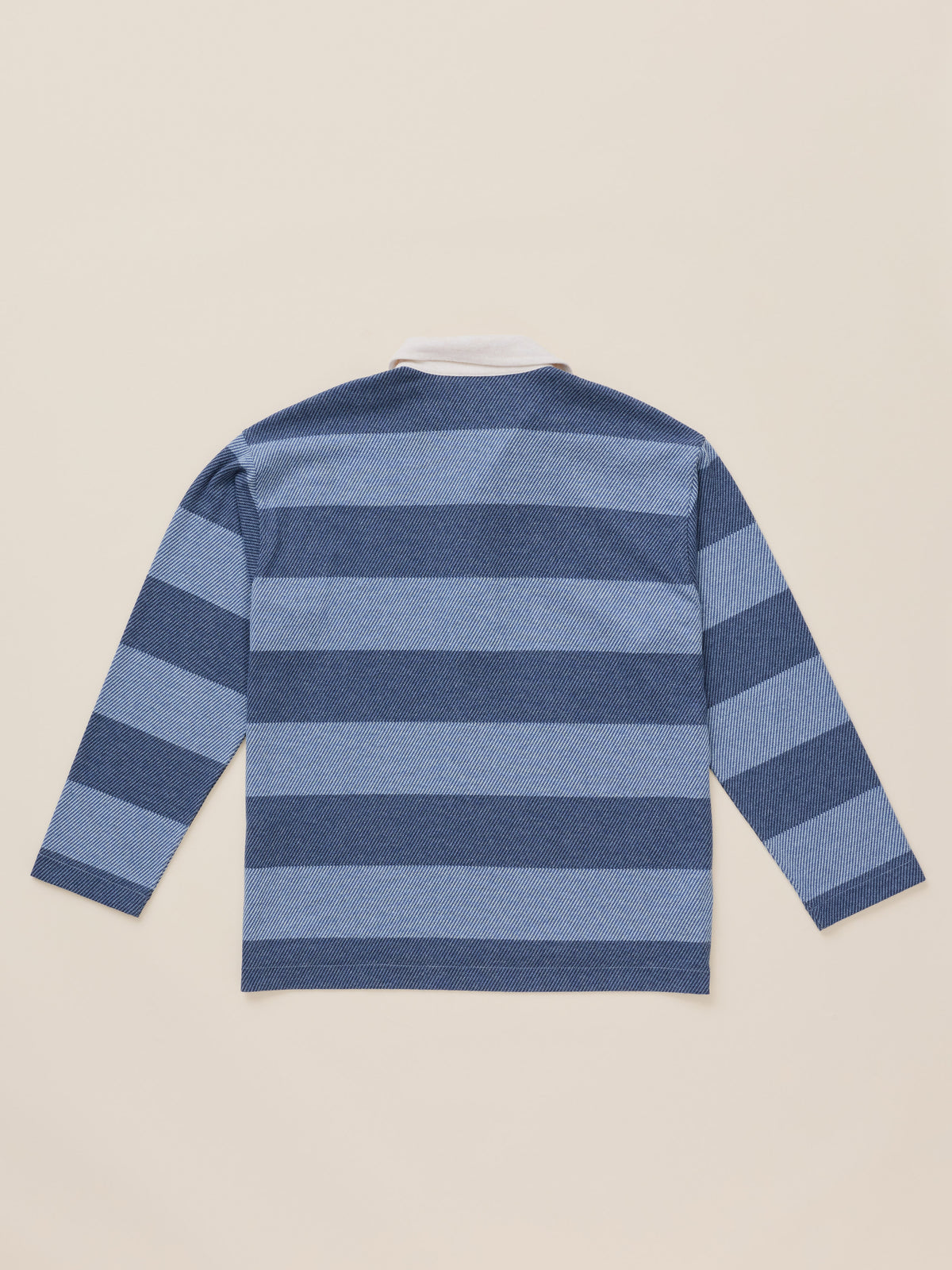 A long-sleeve striped knit top shown from the back, featuring horizontal bands of medium blue and navy blue on a light beige background., image 7 of 7