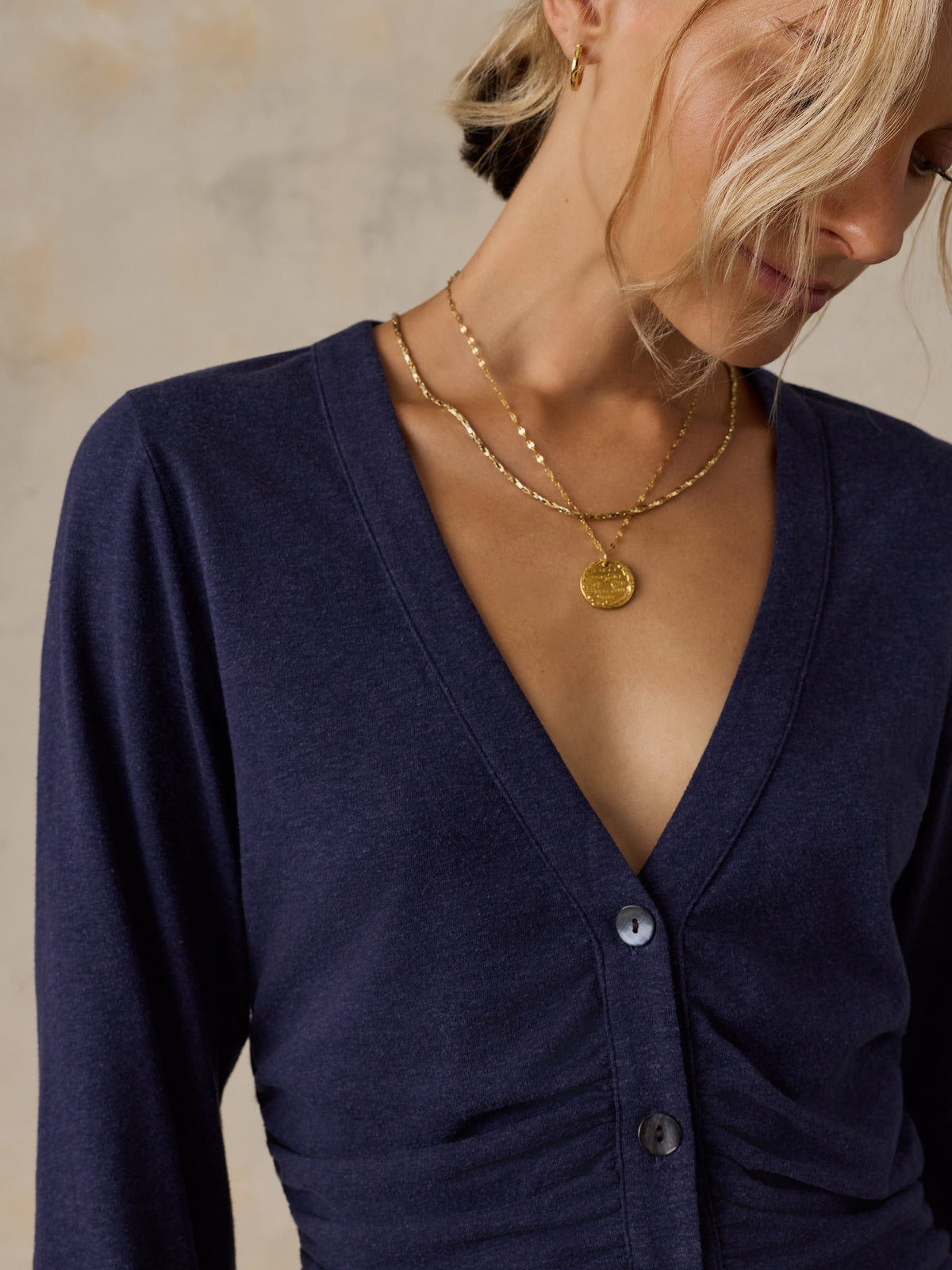 A woman wearing a blue long sleeve top , image 6 of 6