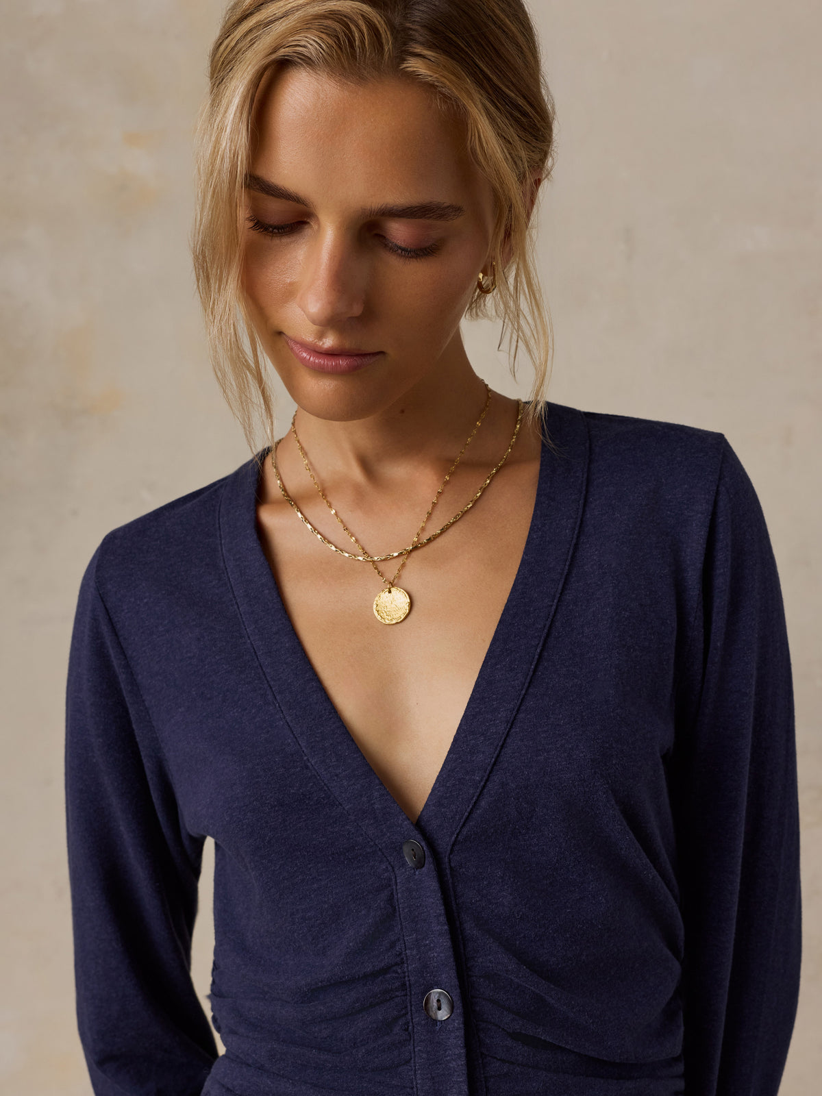 A woman wearing a blue long sleeve top , image 3 of 6