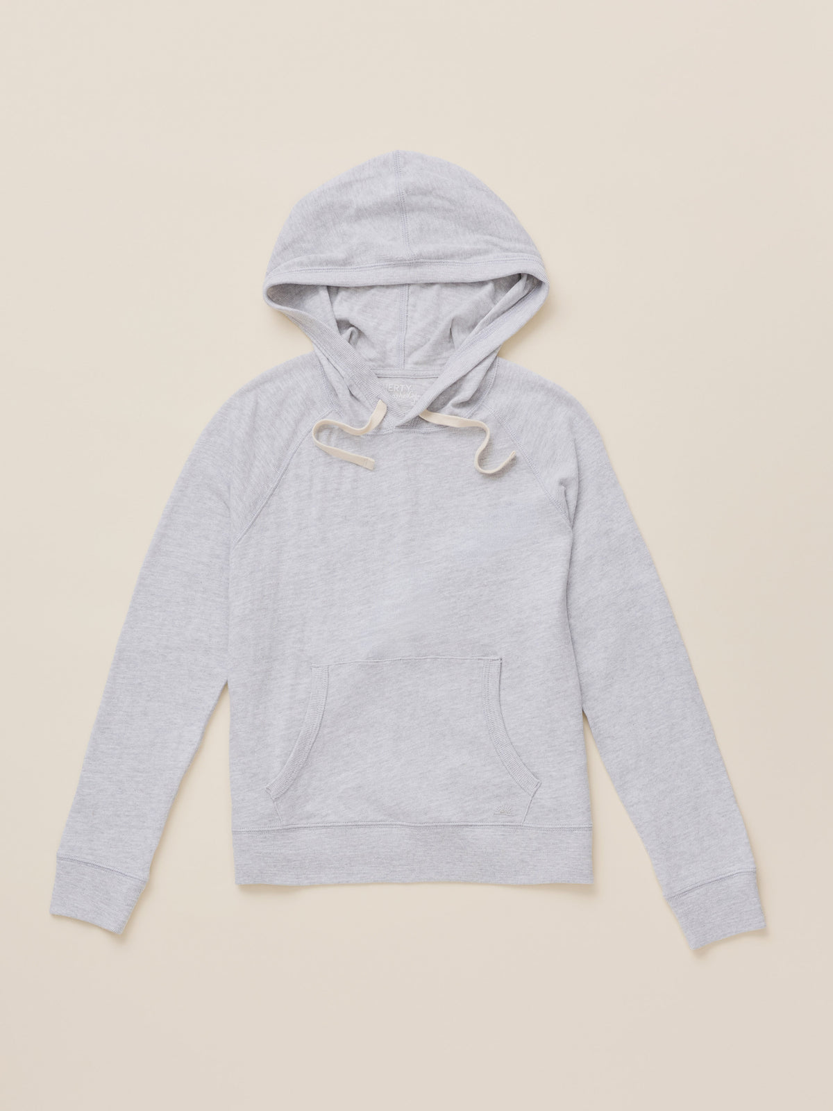 A light gray heather pullover hoodie with white drawstrings, laid flat against a solid beige background., image 6 of 7