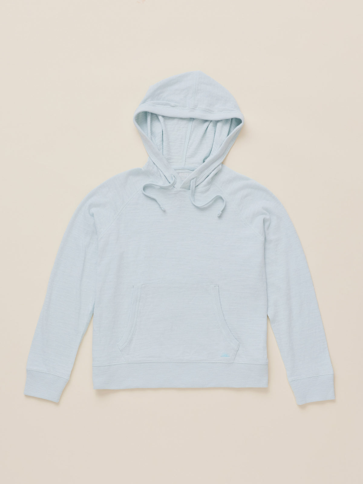A light blue hooded sweatshirt with a front kangaroo pocket, laid flat on a warm beige background., image 6 of 7