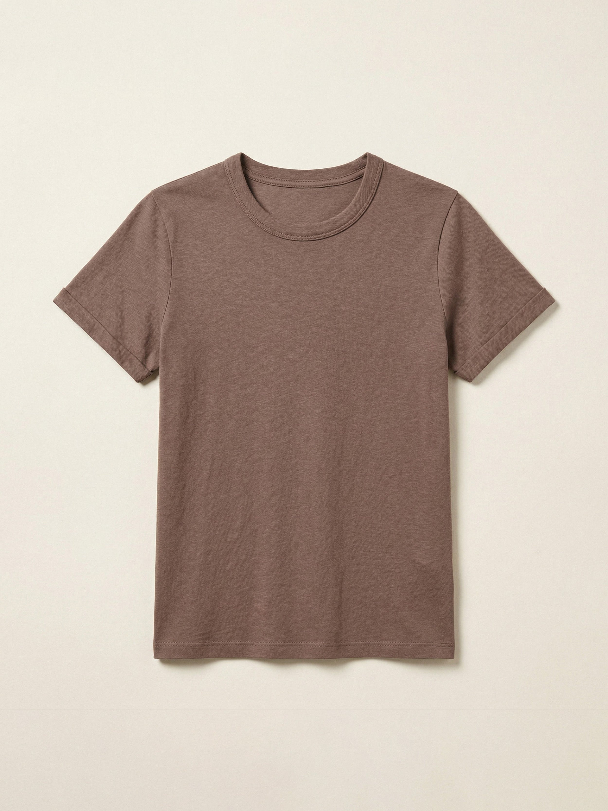 Brown t-shirt against a beige background