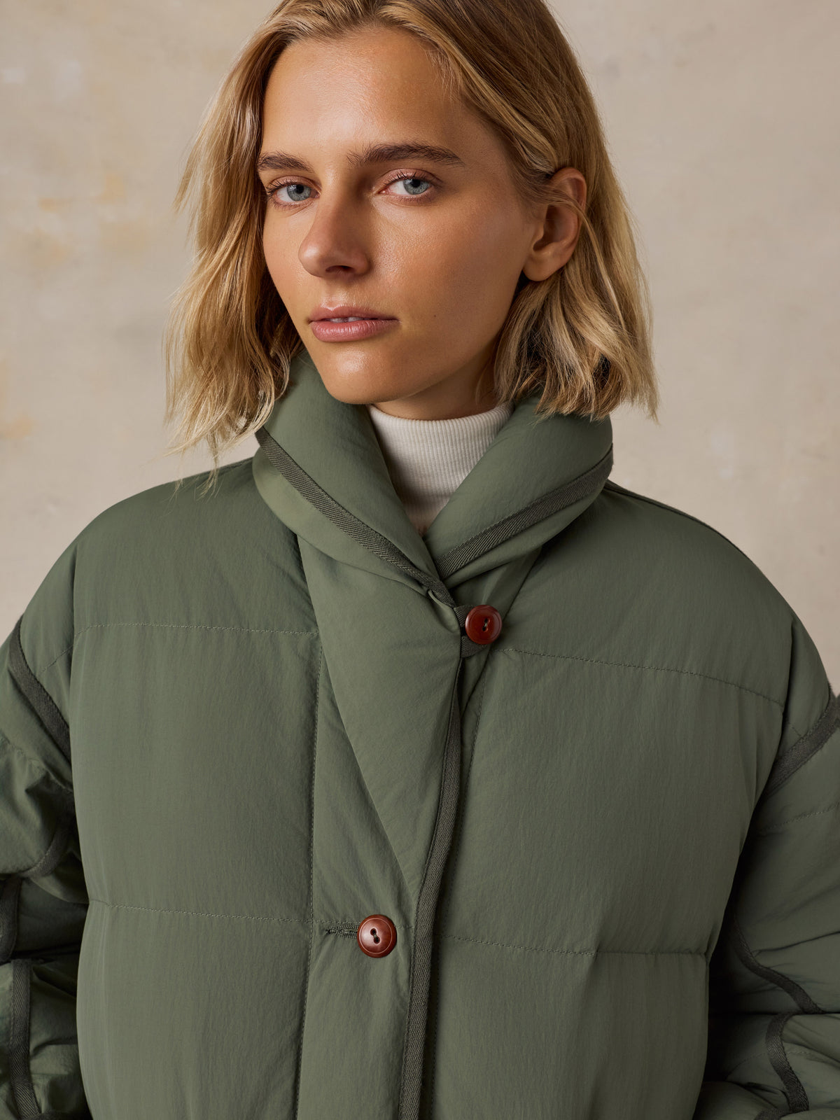 Close up of a woman wearing a green jacket , image 6 of 8