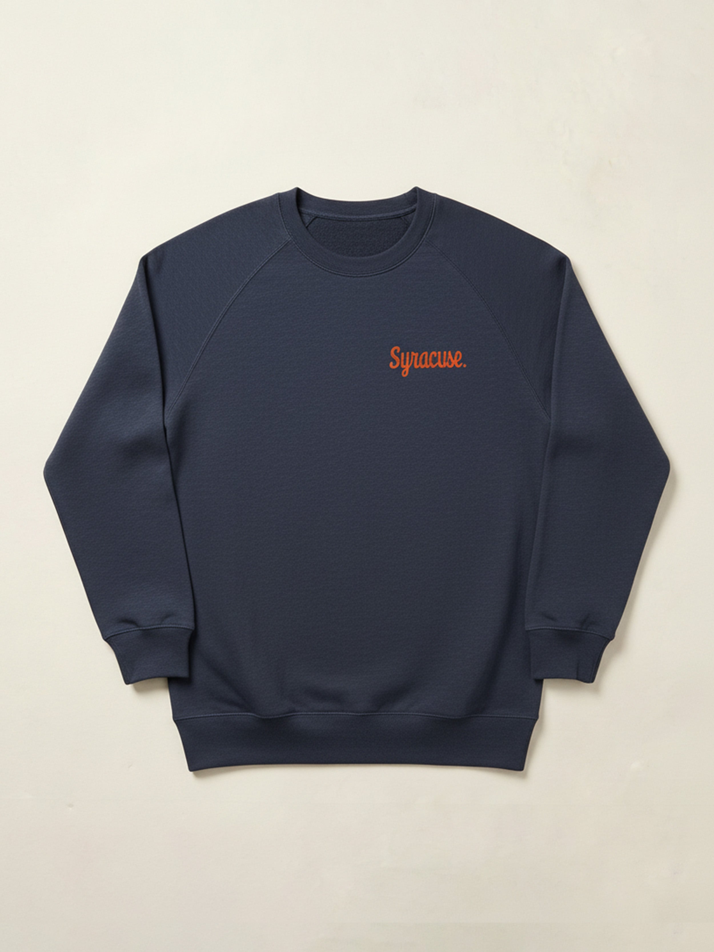 Navy blue sweatshirt with orange Syracuse text on the left chest against a beige background