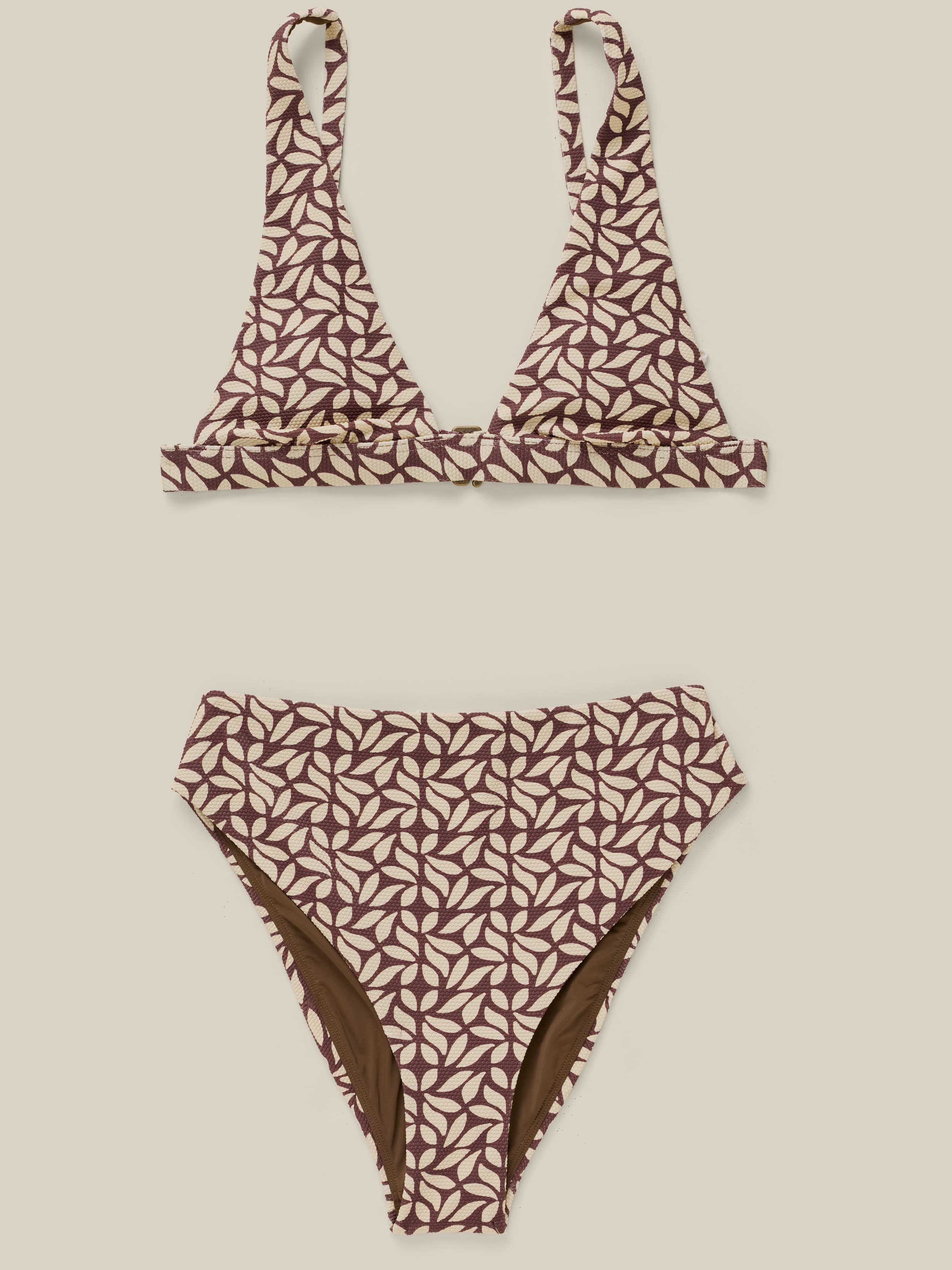 Brown printed bikini against a beige background