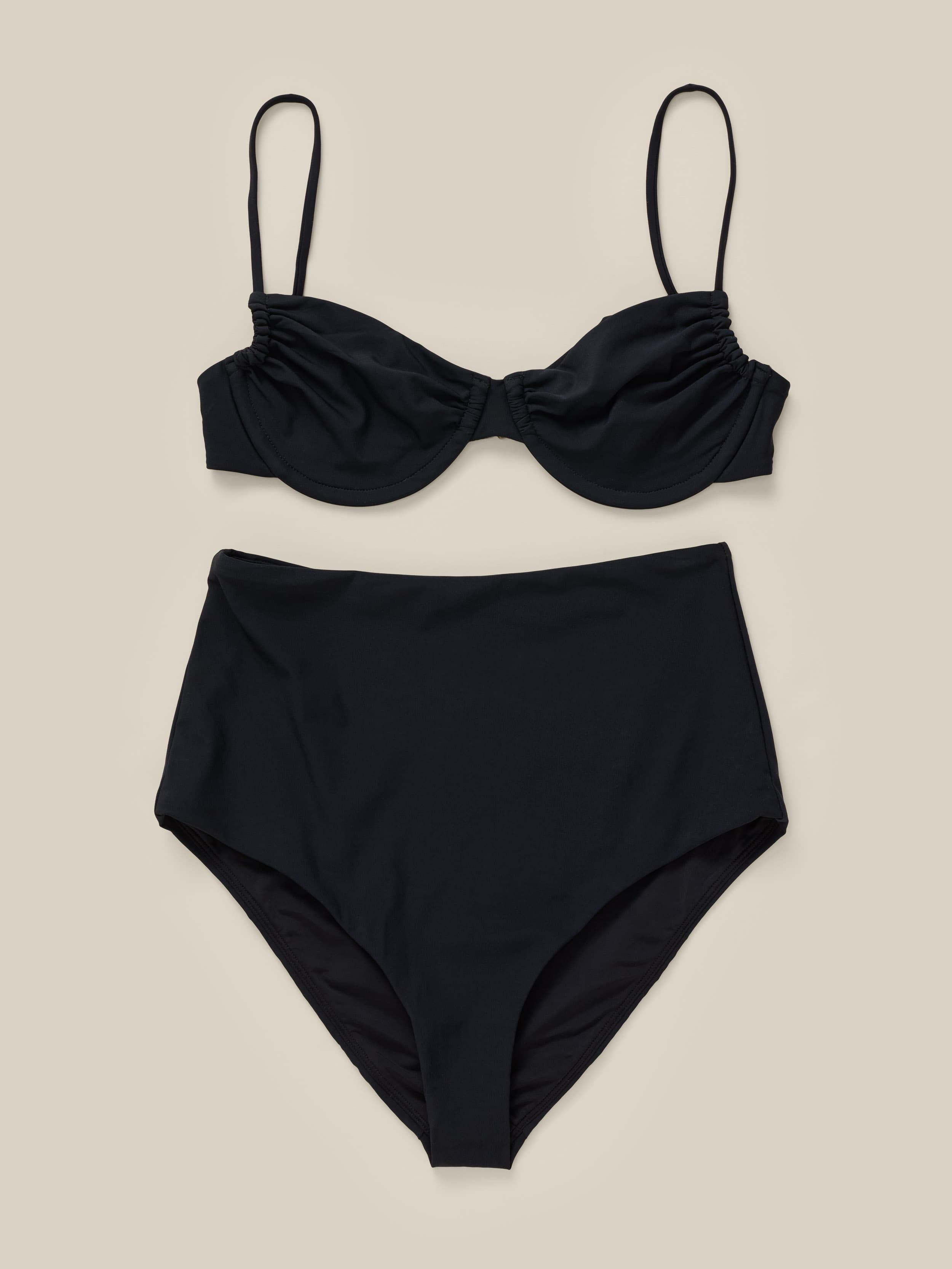 Black bikini set on a beige background