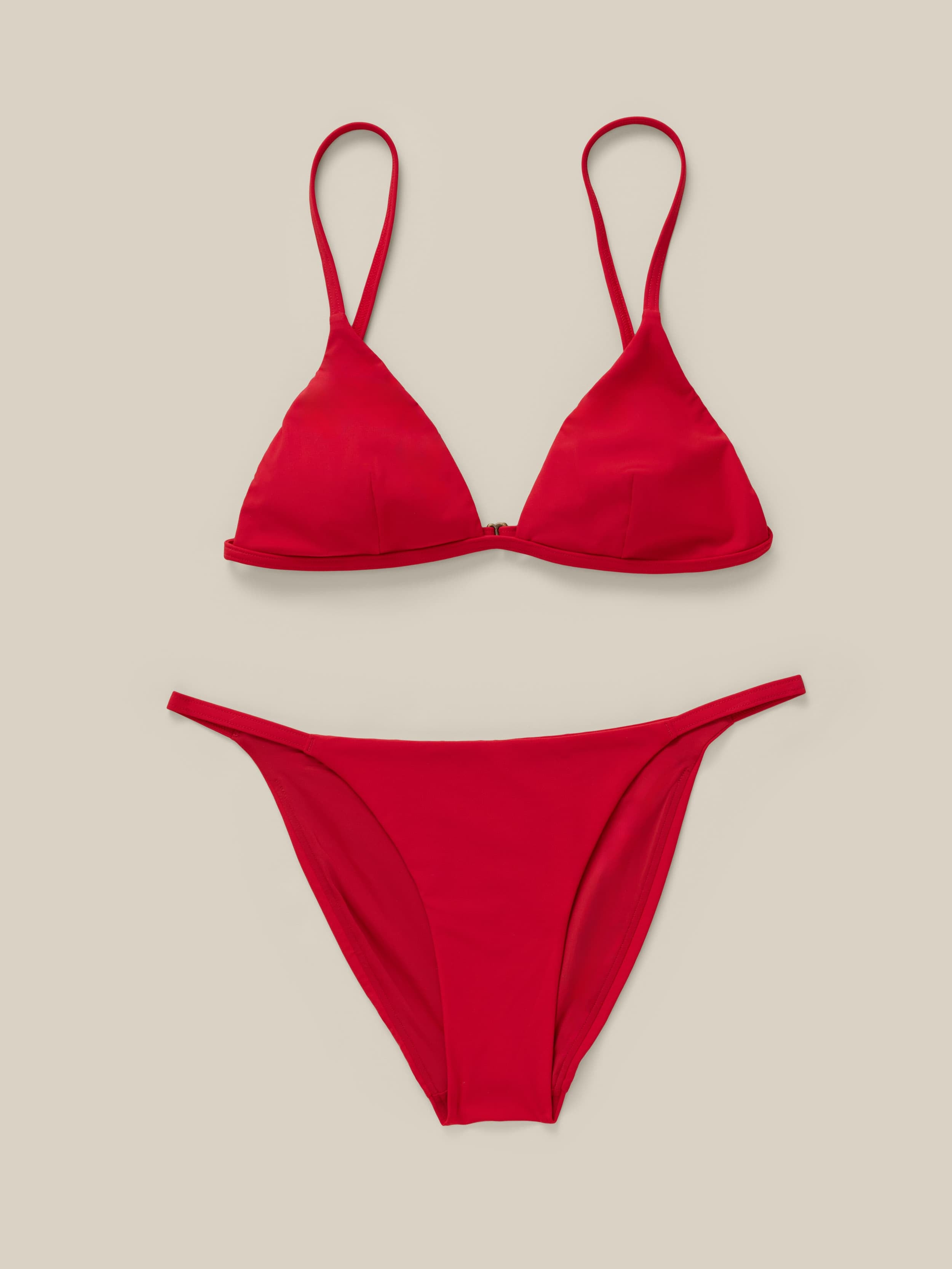 Red bikini set on a beige background