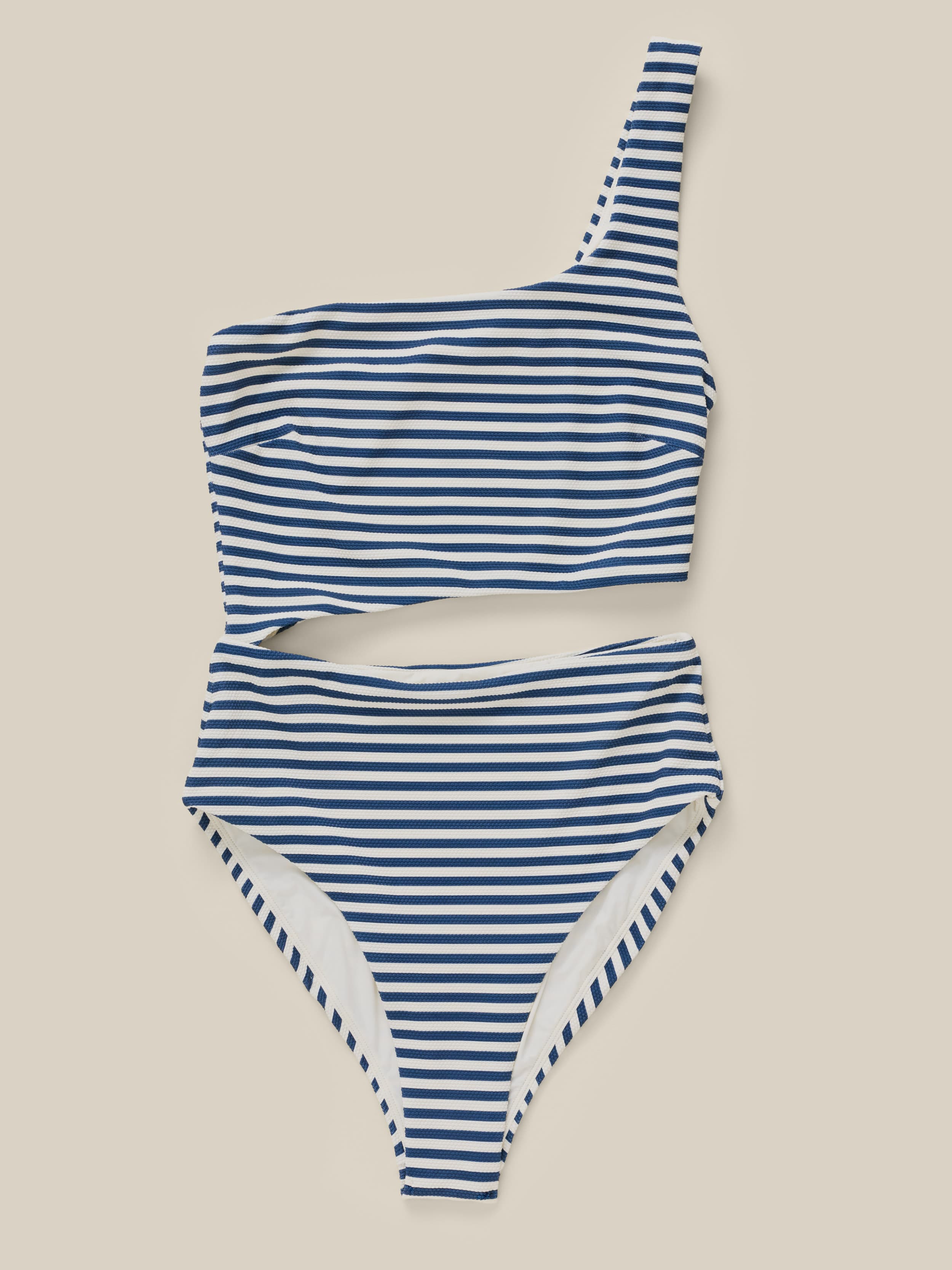 Blue and white striped swimsuit on a beige background