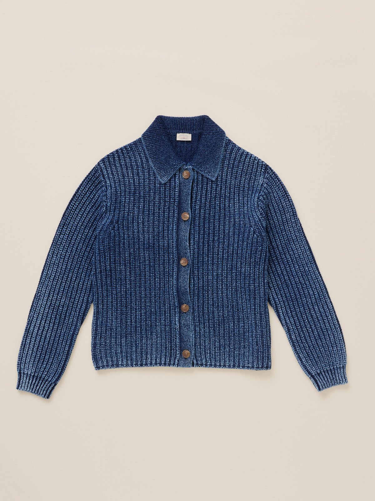 Blue cardigan against a warm beige studio background, image 7 of 8