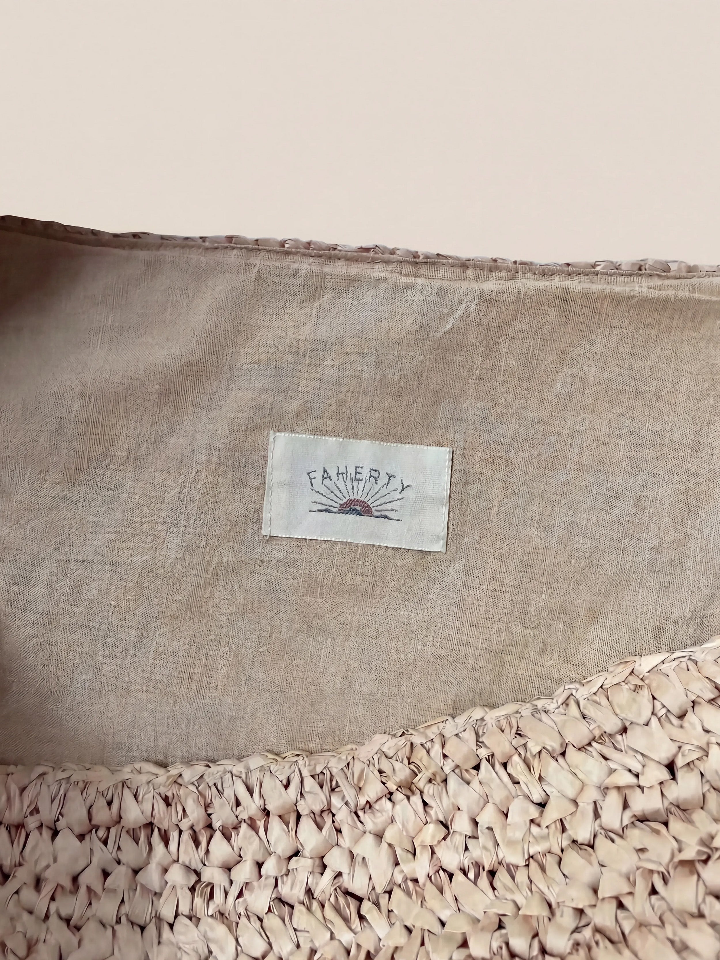 Textile product with a Faherty brand label on a beige background