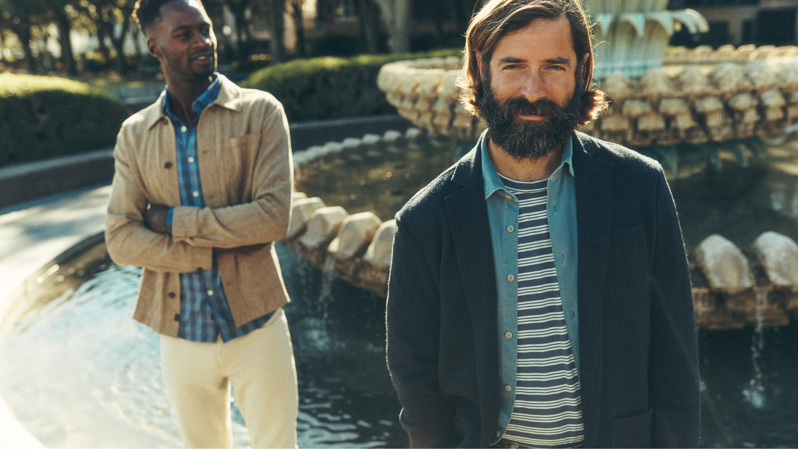 Two men in Faherty Reserve collection standing in front of a fountain