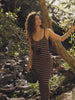 Video of a woman wearing a brown and white striped rib dress near a river.