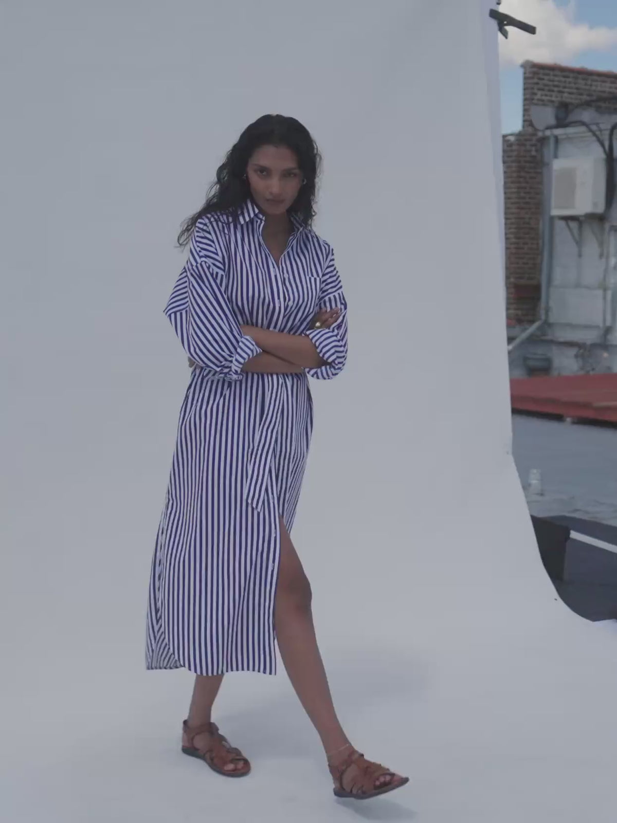 Video of a woman wearing a blue and white striped poplin dress against a white background