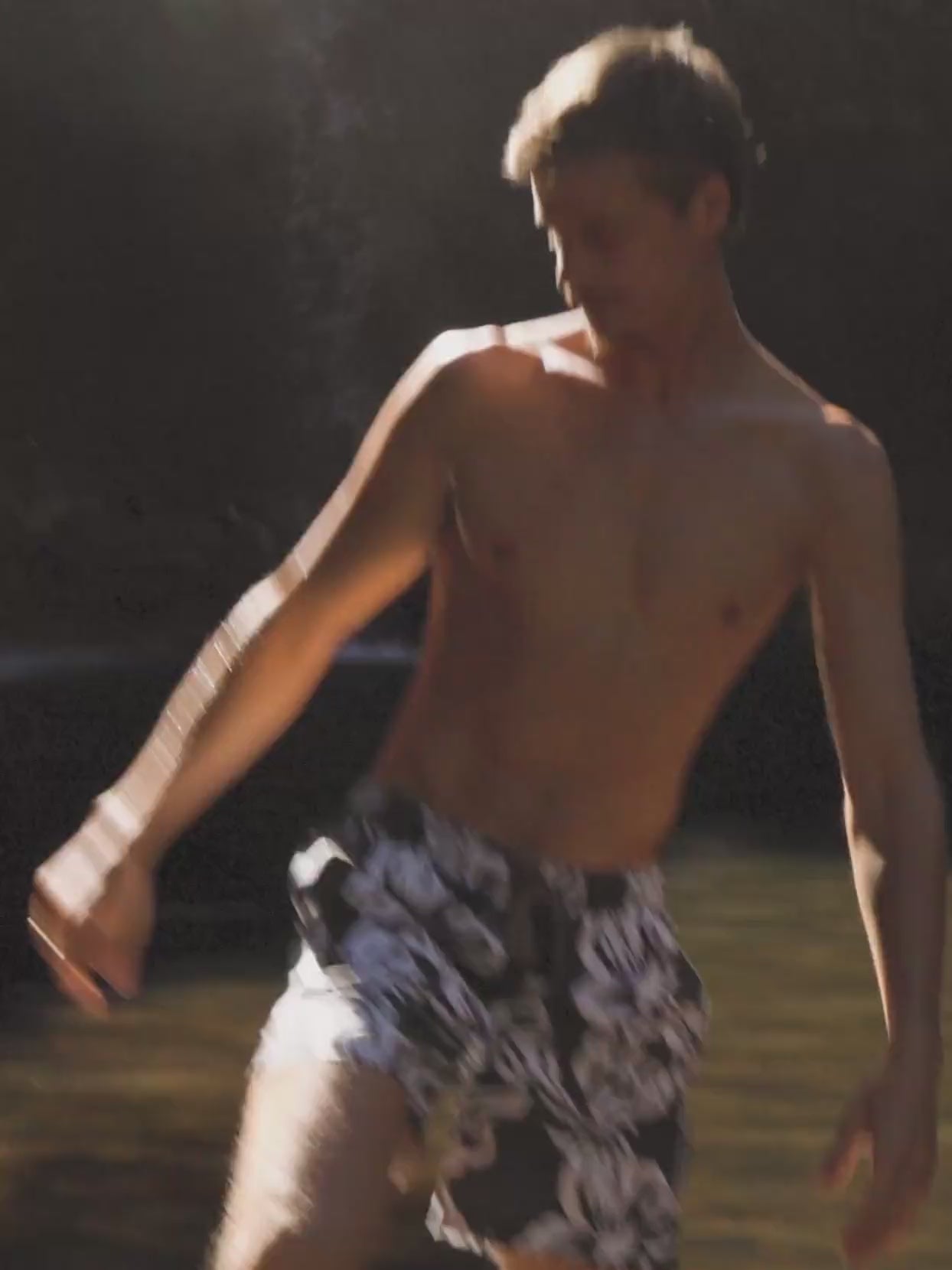 Video of a man wearing floral printed swim shorts in the water
