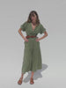 Video of a woman wearing an olive green dress against a white bakground
