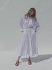 Video of a woman wearing a white poplin top with matching skirt against a white background