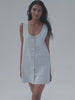 Video of a woman wearing a striped denim dress against a white background