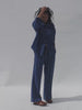 Video of a woman wearing a matching blue striped set against a white background