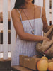Video of a woman wearing a blue striped dress at a farmer's market