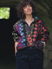 Video of a woman wearing a colorful fleece jacket and navy corduroy pants