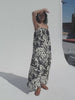 Video of a woman wearing a printed dress against a white background