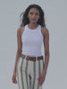 Video of a woman wearing a white tank top with green striped linen pants against a white background